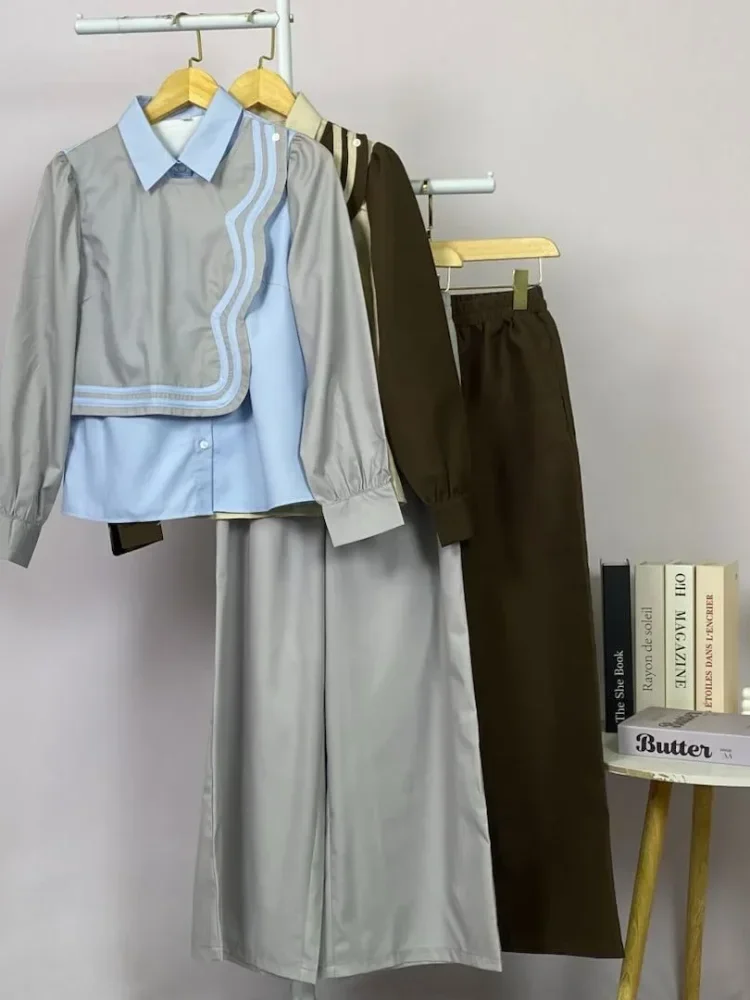 ASAYA Atasan lengan panjang desain braun memiliki efek dua lapis, dipadukan dengan rompi warna kontras dan celana panjang senada, lalu ditumpuk dengan celana panjang setelan tambahan.