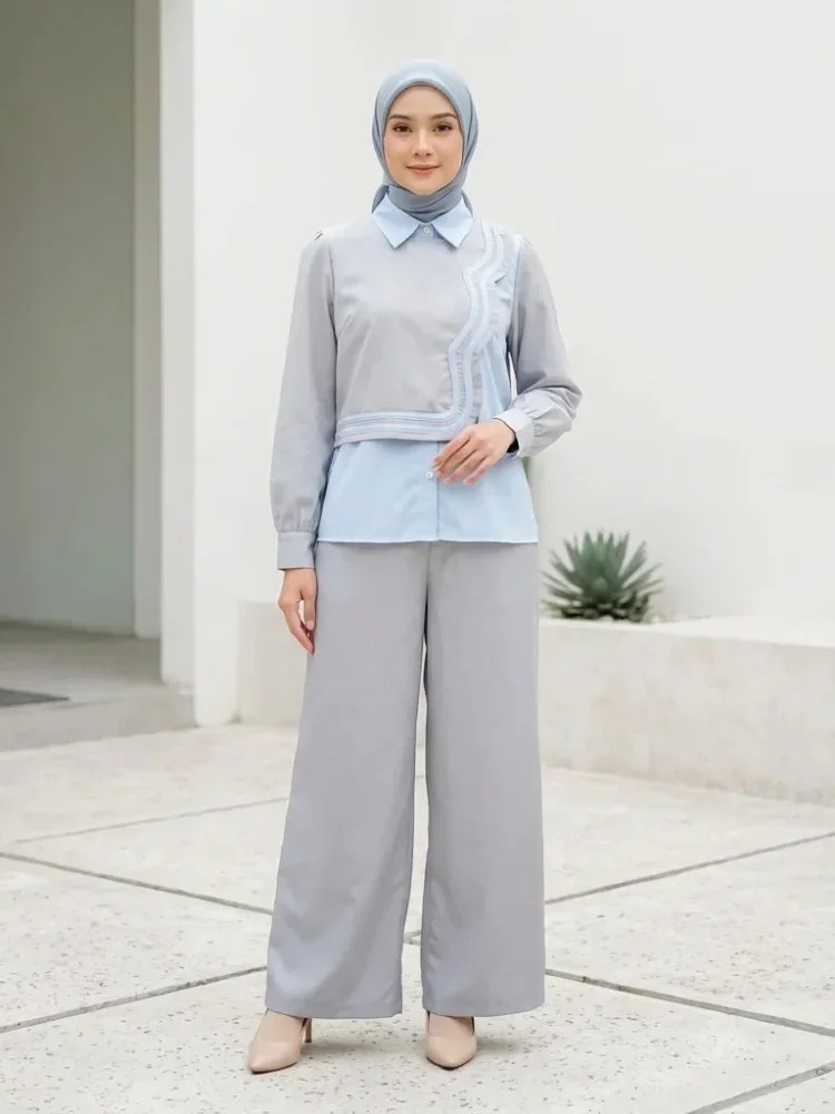 ASAYA Atasan lengan panjang desain braun memiliki efek dua lapis, dipadukan dengan rompi warna kontras dan celana panjang senada, lalu ditumpuk dengan celana panjang setelan tambahan.