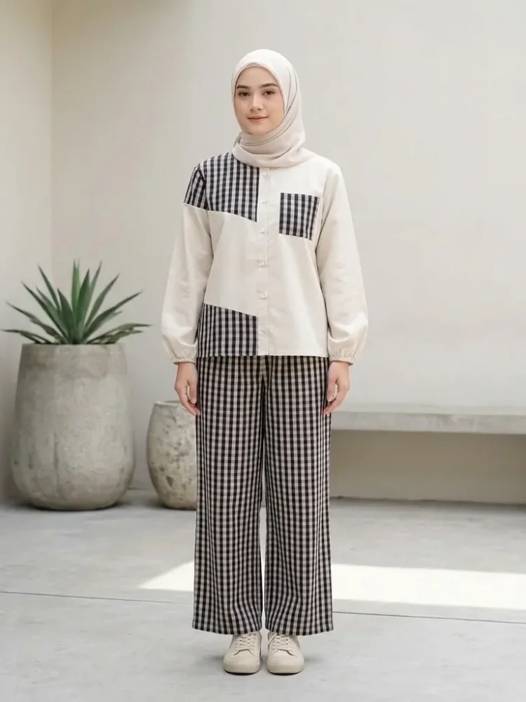 ASAYA Atasan dua potong dengan desain patchwork asimetris dan gaya minimalis, dipadukan dengan celana yang nyaman.