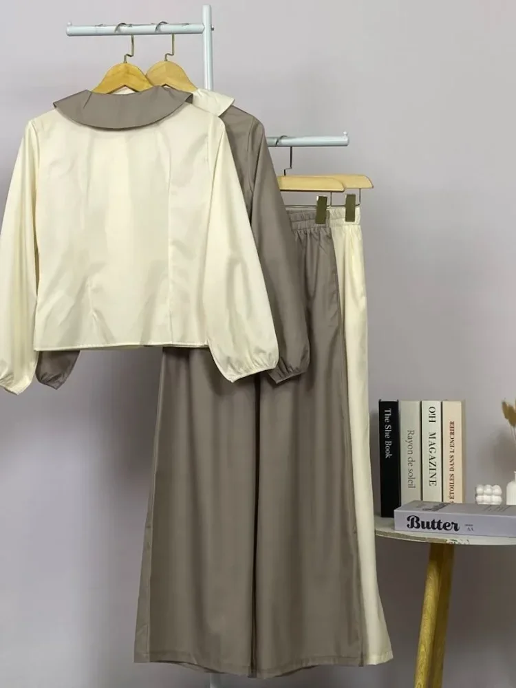 ASAYA Atasan lengan panjang warna polos dengan desain tidak beraturan dan kancing buatan tangan, dipadukan dengan celana panjang polos